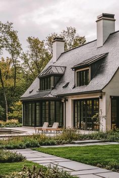 the house is surrounded by lush green grass