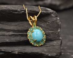 Gold Turquoise Pendant set with a Genuine Natural Arizona Turquoise (Sleeping Beauty) in a stunning clean grade, surrounded by Natural Emeralds. Gold Flower Pendant design is made of Gold Vermeil ☞ thickest 18k Gold Plating on top of Solid 925 Sterling Silver ☞ made to last. Free Gold Vermeil Chain with every Pendant order, 18 inch Gold Vermeil chain (46 cm) ✓ December Birthstone - Genuine & Natural Stones ❀ ⌛Last Pendants left ⌛ Matching Ring: www.etsy.com/uk/listing/1029820990 Matching Earring Turquoise Fine Jewelry Gemstones As A Gift, Turquoise Gemstones For Gift, Fine Jewelry Style, Turquoise Gemstones With Accents For Gifts, Elegant Turquoise Chrysoprase Necklace, December Birthstone Necklace, Blue Topaz Pendant, Arizona Turquoise, Ruby Pendant, Rose Pendant