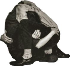 two people sitting on top of each other with their arms around one person's head