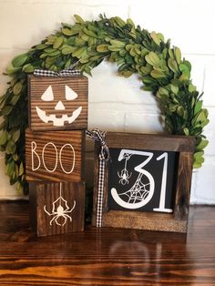 three wooden blocks with numbers on them sitting next to a wreath and door hanger