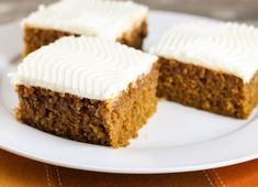 three pieces of carrot cake on a white plate