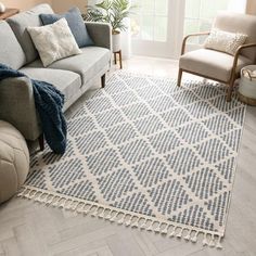 a living room with a couch, chair and rug