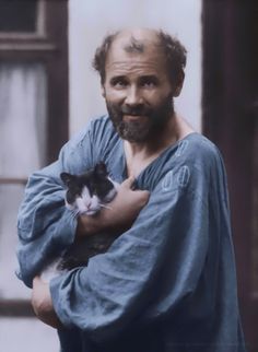 a man holding a cat in his arms