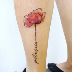 a woman's leg with a flower tattoo on it