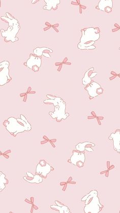 a pink background with white rabbits and bows