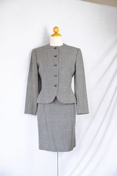 "Vintage houndstooth wool jacket and skirt suit by Bill Blass commissioned for I.Magnin stores. Jacket flares out slightly at the waist, includes loops for a skinny belt. In great condition. Made in the U.S.A. with union label still attached. Jacket is labeled 6 but best fits a size 4. Skirt is labeled 6 US but fits best fits a 24-25 waist size. There is one small faint stain on the jacket, see the last image for details. Measurements Skirt: Waist 12\" Length 20\" Jacket: Shoulder 15\" Length 22 Daytime Dress, Vintage Houndstooth, Houndstooth Jacket, Skirt Suit Set, Bill Blass, Daytime Dresses, White Houndstooth, Pink Midi Dress, Womens Blazers