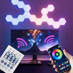 a person holding a remote control in front of a flat screen tv with colorful lights