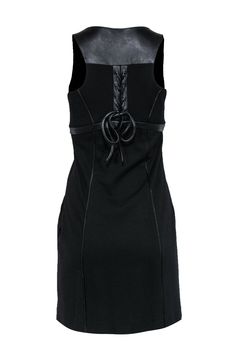 Mix classic and edgy styles with this subtle statement dress from Cynthia Steffe! Made with a smooth leather trim, lace-up back design and fitted silhouette, this is an eye-catching piece you don't want to miss! Slip on some Mary Jane heels for a sweet look, or amp it up with some chunky boots. Size 2 69% Rayon, 26% Nylon, 5% Spandex Babydoll silhouette Smooth leather trim and buttons Scoop neckline Lace-up back design Side zipper closure Waist 28" Bust 32" Total length 35" Fall Dresses With Lace-up Back, Fitted Black Mini Dress With Strap Detailing, Black Formal Dress With Lace-up Back, Black Dress With Lace-up Back For Formal Events, Fitted Black Dress With Strap Detailing, Black Fitted Dress With Strap Detailing, Edgy Fitted Leather Dress, Fitted Black Leather Dress, Black Fitted Leather Dress