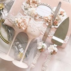 there are some wedding cake utensils on the table with flowers and laces