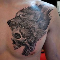 a man with a tattoo on his chest has a lion and skull in the middle