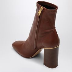 Hey there. Looking for that perfect pair of cognac leather boots to elevate your wardrobe? These ankle beauties blend classic style with modern flair, making them a versatile addition to any outfit. Plus, they’re crafted with care, so you know they’ve got the quality to match their gorgeous looks. Rich cognac-colored leather Chic square toe design Easy-to-use inner side zip Sturdy thick wood-effect high heel Durable leather sole Made in Italy 100% calf leather composition | Chloé Women's Ambre A Dr Closet, Boot Pumps, Leather Cap, Brown Ankle Boots, Beach Tote Bags, Sneaker Heels, Womens Boots Ankle, Sophisticated Style, Handbag Backpack