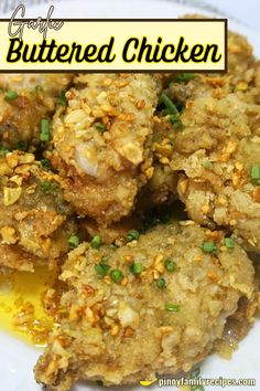 a close up of food on a plate with the words buttered chicken above it