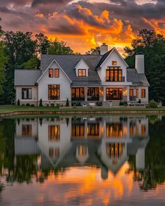 a large white house sitting on top of a lake