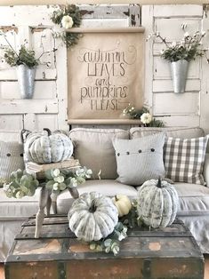 a living room filled with lots of furniture and flowers on top of the couches