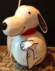 a white dog figurine sitting on top of a counter