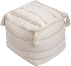 a white ottoman with tassels on it