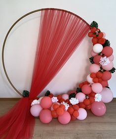 the balloon arch is decorated with pink, red and white balloons