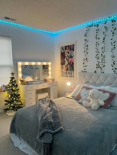 a bedroom decorated for christmas with lights on the ceiling