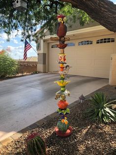 a birdhouse made out of glass in front of a house