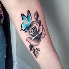 a woman's arm with a butterfly on it and a rose in the middle