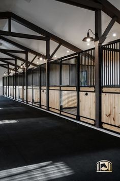 an empty room with wooden partitions on the walls and black carpeted flooring