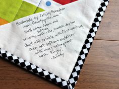 a close up of a piece of cloth on a table with words written in it