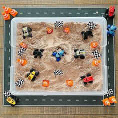 an overhead view of a play area with cars and sand