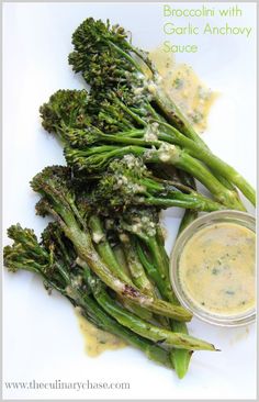 broccoli with garlic anchovy sauce on a white plate