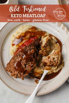 a white plate topped with meatloaf covered in gravy