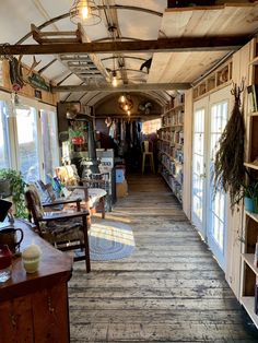 the inside of a store with lots of shelves and chairs on each side of the room