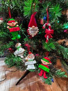 an ornament is hanging on the christmas tree in front of a wooden table