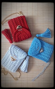 three crocheted purses sitting on top of a table