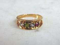 FOR SALE IS THIS WONDERFUL WOMENS 10K YELLOW GOLD RING WITH DIAMONDS AND GEMSTONES. THE RING WEIGHS 3.99g. THE SIZE OF THE RING IS AN 8. DIAMOND WEIGHT IS HALF A CARAT. ANY QUESTIONS PLEASE DO NOT HESITATE TO ASK. BE SURE TO CHECK OUT SOME OF MY OTHER GREAT ITEMS UP FOR SALE. THANK YOU. IF THERE ARE ANY ISSUES PLEASE CONTACT US, WE'RE ALWAYS HAPPY TO TRY TO HELP YOU OUT AS BEST AS WE CAN. Classic Gold Multi-stone Birthstone Ring, Gold Multi-stone Birthstone Ring For Anniversary, Tiara Ring, Yellow Gold Diamond Ring, Chalcedony Ring, Mood Ring, Sapphire Diamond Ring, Yellow Gold Ring, Multi Stone Ring