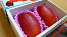 two red eggs in a box on a table