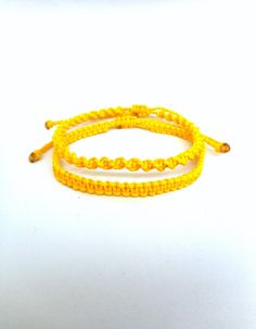 "Yellow macrame bracelets, Twisted and flat knotted Classic macrame friendship bracelets perfect for everyday wear! These handknotted bracelets are made with durable yellow waxed string. They are adjustable and have a sliding knot closure in order to fit a lot of sizes. Due to their waxed threads,the bracelets are very durable and water resistant. Width: 0.4cm / 0.15\" The price is for one bracelet.Or choose the set of 2 to save on shipping! Similar bracelets: https://www.etsy.com/listing/227376 Yellow Friendship Bracelet, Rat Jewellery, Yellow Macrame, Movie Outfit, Bts Bracelet, Jewelry Everyday, Sliding Knot Closure, Beach Bracelet, Yellow Bracelet