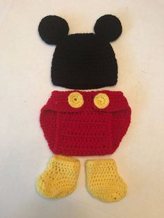 a crocheted mickey mouse hat and diaper cover on a white tablecloth