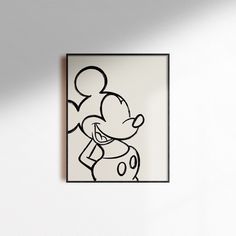 a black and white drawing of a mickey mouse on a wall with a shadow over it