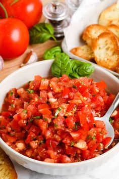 a white bowl filled with chopped tomatoes and bread