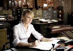 a woman sitting at a desk in an office