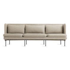 a beige couch with black legs on a white background