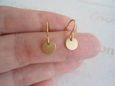 Gold minimalist tiny earrings. This pair of earrings for person who is looking for the smallest earrings - these are the ones ! Tiny disks attached to the surgical steel gold plated fish hooks style . The disks are brass gold plated . If you need silver version of these earrings you can find here : Cheap Round Earrings With Tiny Beads, Cheap Small Earrings As A Gift, Cheap Round Disc Earrings For Gifts, Cheap Round Disc Earrings For Gift, Cheap Small Handmade Earrings, Cheap Round Disc Earrings As Gift, Affordable Dainty Round Earrings, Cheap Everyday Earrings With Tiny Beads, Jewelry Minimal