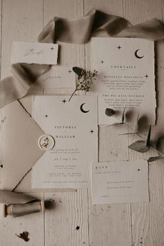 the wedding stationery is laid out on top of each other