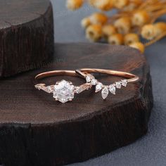 two rose cut diamond rings on top of a piece of wood