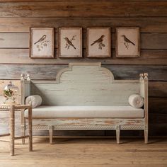 a white couch sitting next to two framed pictures