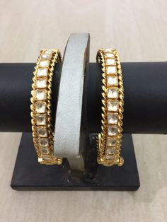 *This is Gold Finish Kundan Bangles pair.Its Perfect for Wedding Occasion as well as Unique and Ethnic Traditional Bangle to gift and Also Bridal wear to match with Wedding Outfits. *Its made from Silver n Copper mix material and 100% Handmade. *Its available in Various Sizes like 2,2.2,2.4,2.6 Etc Its white kundan combination like shown in picture. *Its open able Screwed Bangles Pair. *All Kundan stones set with silver foils handsetting method and long last guarantee of its workmanship.It is Wh Diwali Reception Bangle Bracelets, Stone Work Bracelets For Diwali Reception, Stone Work Bracelets For Reception And Diwali, White Temple Jewelry Bracelets With Stone Work, Traditional Meenakari Bracelets For Reception, White Temple Jewelry Bracelet With Stone Work, Traditional Stone Work Bangle For Reception, Temple Jewelry Bangle For Festivals And Receptions, Temple Jewelry Bangle For Receptions And Festivals