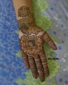 a woman's hand painted with hennap and intricate designs on her hands