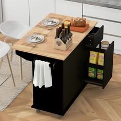 a small kitchen island with food and drinks on the top, next to two chairs