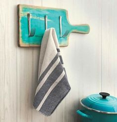 a towel hanging on the wall next to a pot and pan