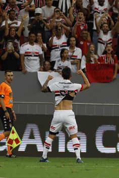 a soccer player is celebrating his team's victory over the opposing team in front of an audience