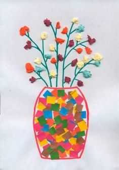 a vase filled with flowers on top of a white sheet of paper and colored stickers